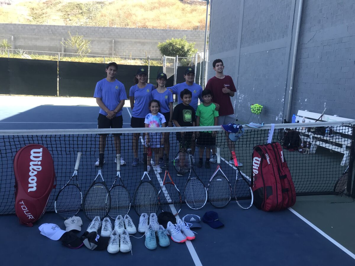Kids in Tecate, Mexico, are shown after receiving tennis equipment from Second Serve.