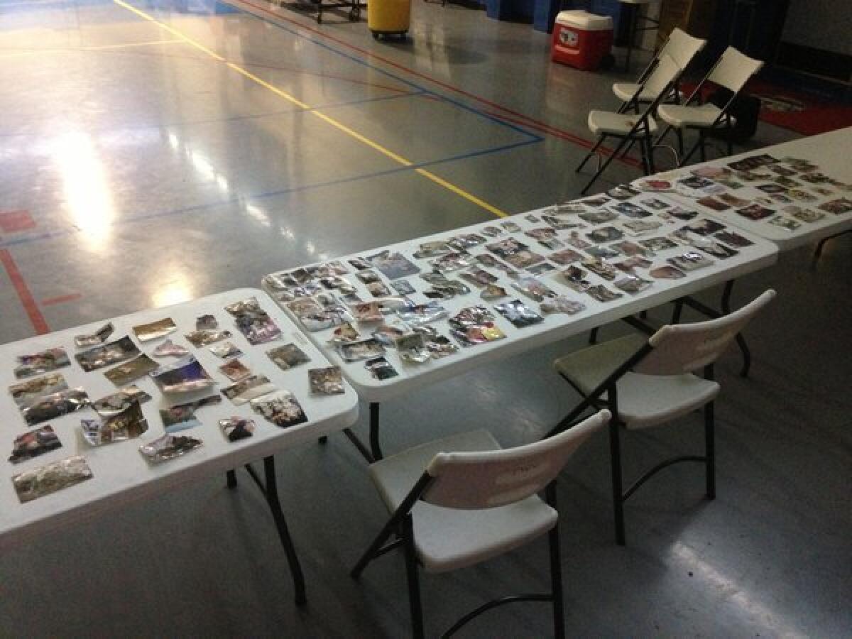 Whether crumpled or warped, personal photographs saved from the twister's rubble are cleaned and collected at the Moore Community Center in hopes they will be reunited with their owners.