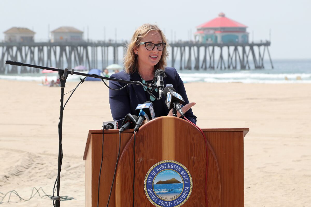 Councilwoman Natalie Moser speaks during a ribbon-cutting ceremony for the first Mobi-Mat in Huntington Beach on Wednesday.
