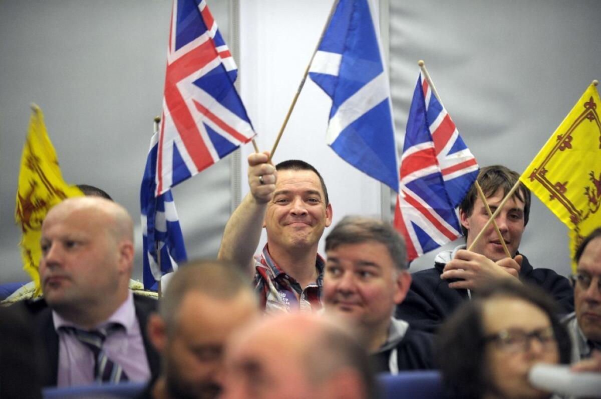 Members of the audience wave Union flags and Scottish flags at a rally opposing Scottish independence.