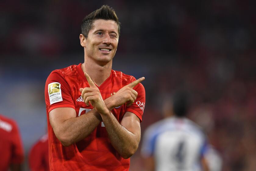 (FILES) In this file photo taken on August 16, 2019 Bayern Munich's Polish forward Robert Lewandowski celebrates scoring the opening goal during the German First division Bundesliga football match FC Bayern Munich v Hertha Berlin in Munich, southern Germany. - Lewandowski has signed a new contract with Bayern until 2023 the club announced on August 29, 2019. (Photo by Christof STACHE / AFP) (Photo credit should read CHRISTOF STACHE/AFP/Getty Images)