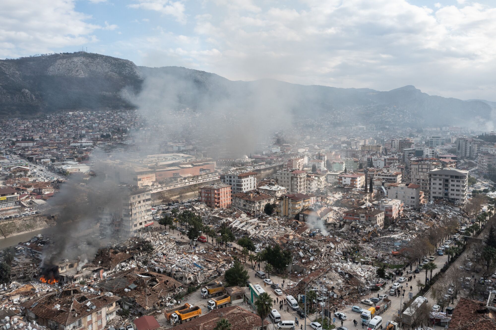 Smoke billows from the scene of collapsed buildings in Hatay, Turkey.