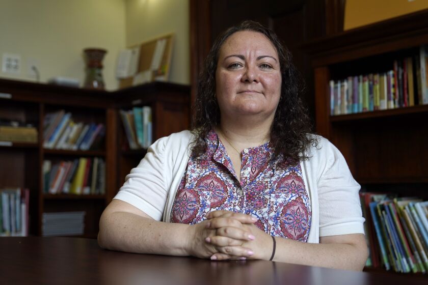 Dr. Michelle LaRue sits for a portrait in Hyattsville, Md., on Wednesday, Aug. 12, 2019. LaRue is a manager at CASA de Maryland, an immigration advocacy group that has partnered with health officials in Prince George's County just outside of Washington. D.C., to make the calls to Spanish speakers. She said earning trust begins with hiring contact tracers who not only speak Spanish but also intimately understand immigrant communities. (AP Photo/Julio Cortez)