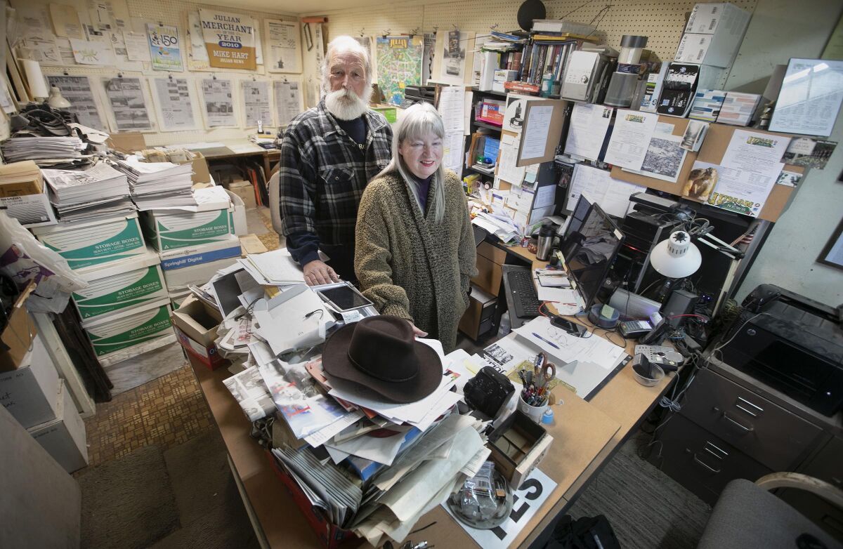 Michael Hart and his wife Michele Harvey have run the Julian News in Julian, CA for almost 17 years. They were photographed in their tiny, cluttered offices on March 11, 2020.