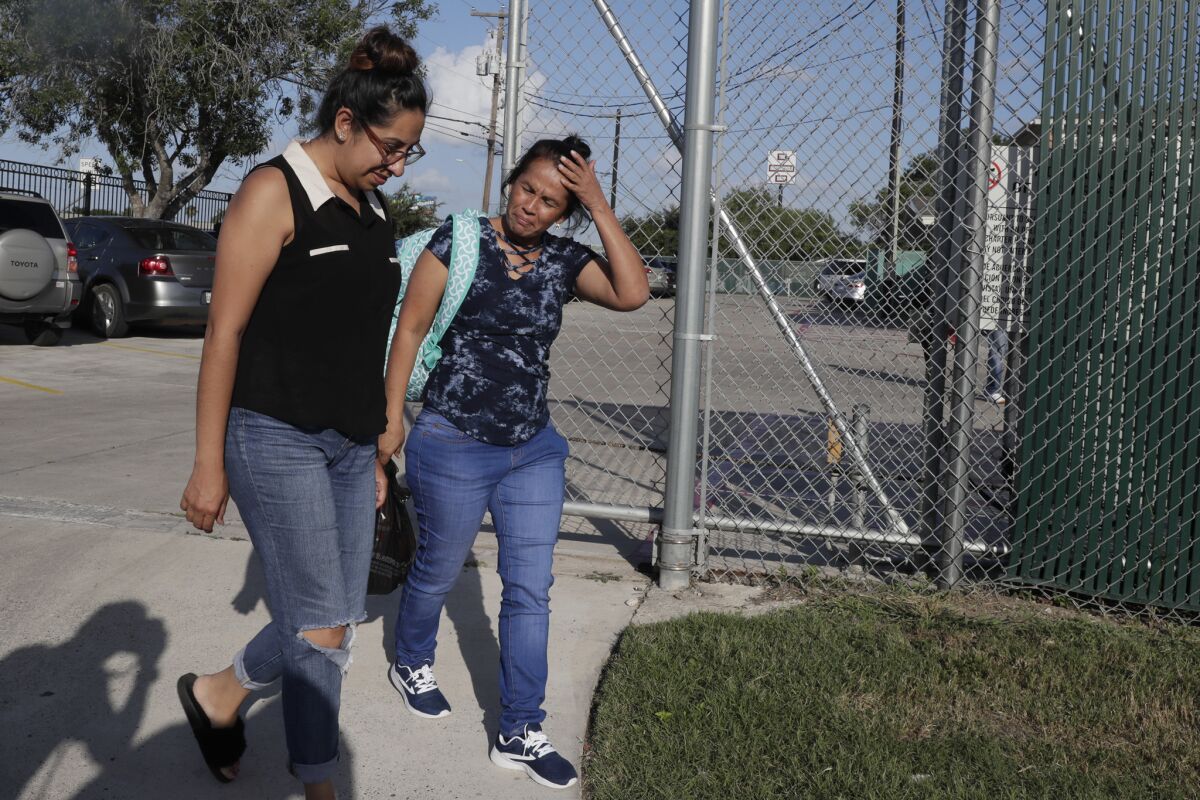 Claudia Munoz, left, escorts a woman from Casa Antigua, a group home run by Southwest Key in San Benito, Texas, where she visited her 15-year-old daughter for the first time since being apprehended by Border Patrol on May 24.