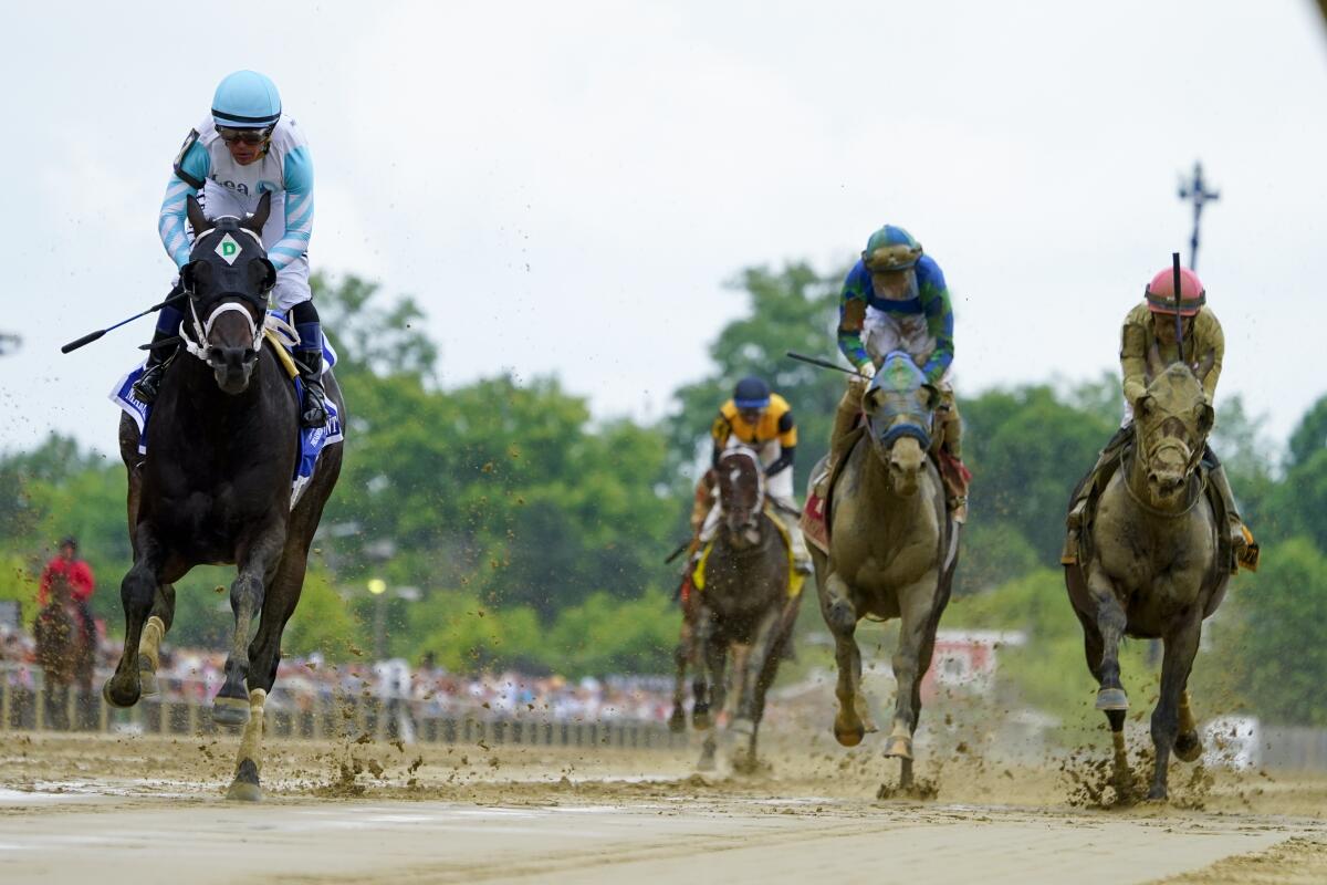 Super Chow, left, with jockey Jorge Delgado, wins the Maryland Sprint undercard horse race ahead of the Preakness Stakes