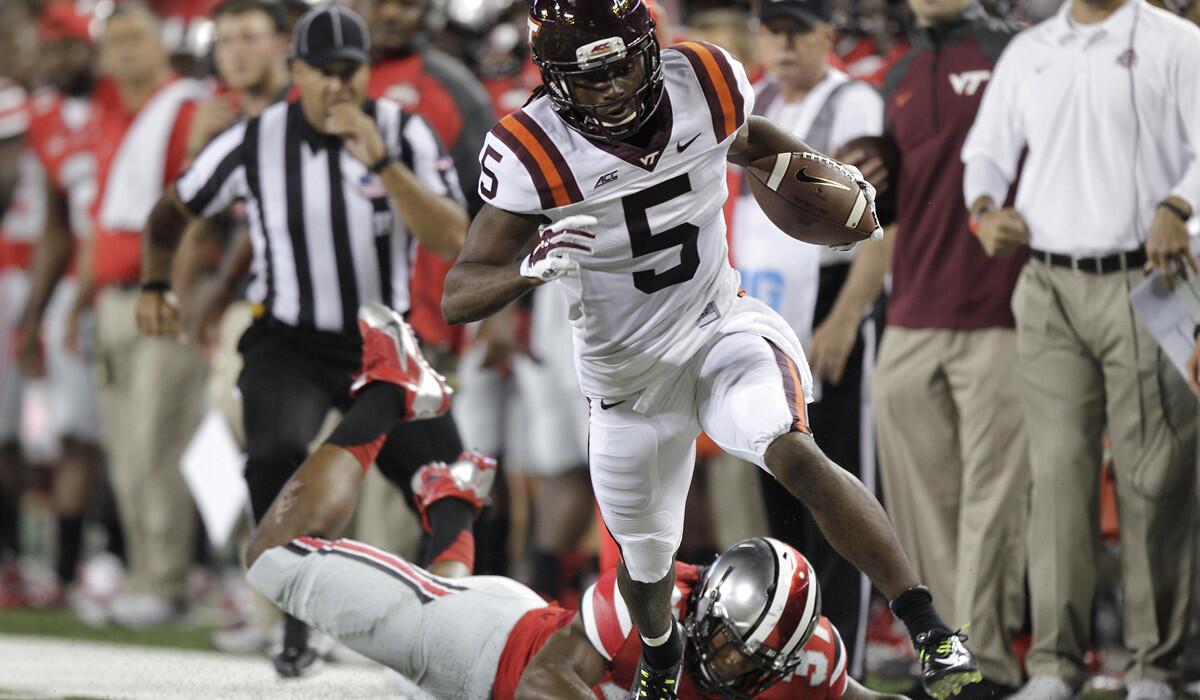 Virginia Tech wide receiver Joshua Stanford gets past a diving Ohio State defender during a game in Columbus, Ohio last season. The Buckeyes' only lost last season were to the Hookies.