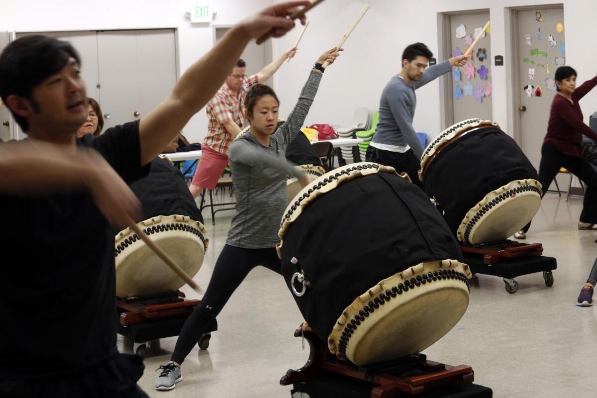 Taiko is good exercise; it offers an excellent cardio workout, builds endurance and employs most joints. Masato Baba, left, leads a TaikoProject drumming class in L.A.'s Little Tokyo.