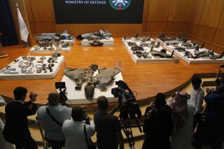 Journalists film what a Saudi military spokesman said was evidence of Iranian weaponry used in an attack in 2019.