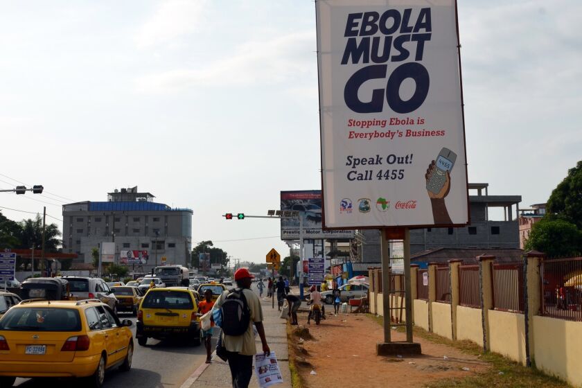 The campaign against the disease continues with a new slogan, "Ebola Must Go," in Liberia's capital city, Monrovia.