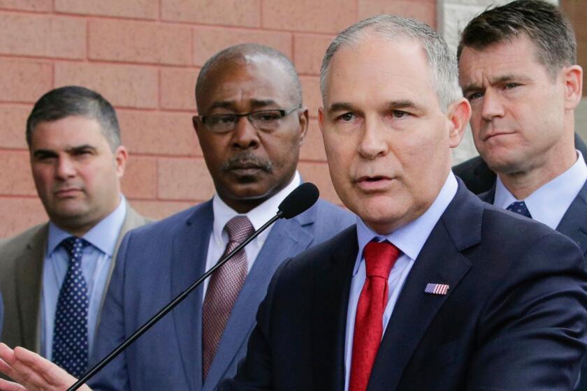 FILE - In this April 19, 2017, file photo, Environmental Protection Agency Administrator Scott Pruitt speaks at a news conference with Pasquale "Nino" Perrotta, second from left, in East Chicago, Ind. Pruitt is announcing the departure of two top aides amid ethics investigations at the agency. Pruitt says his security chief, Pasquale "Nino" Perrotta, was retiring. He gave no cause, but Pruitt's spending on security at the EPA is the subject of ongoing federal investigations. Pruitt also announced the departure of Albert Kelly, a former Oklahoma banker in charge of the toxic waste cleanups. (AP Photo/Teresa Crawford, File)