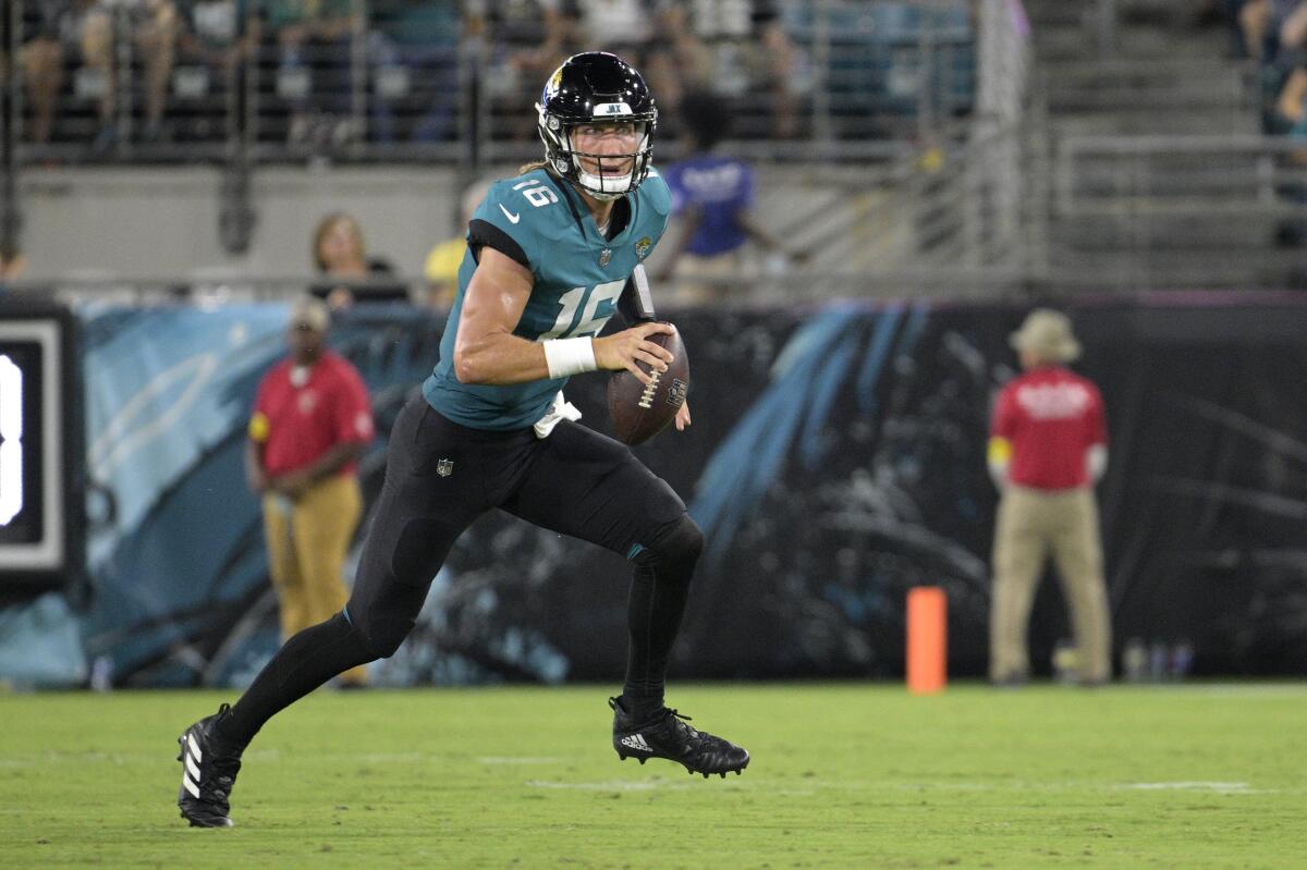 Jacksonville Jaguars quarterback Trevor Lawrence scrambles for yardage.