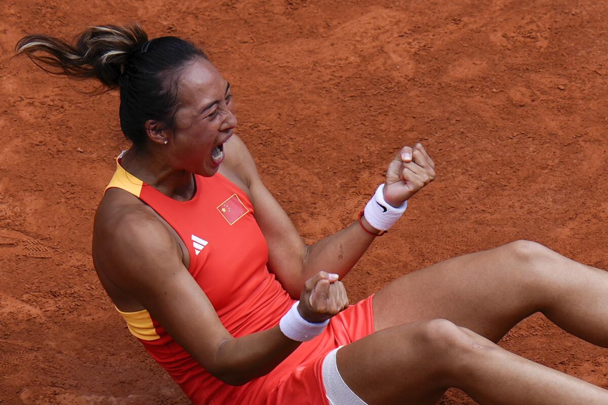 Zheng Qinwen celebrates after defeating Iga Swiatek in the women's singles semifinals at the Paris Olympics on Thursday.