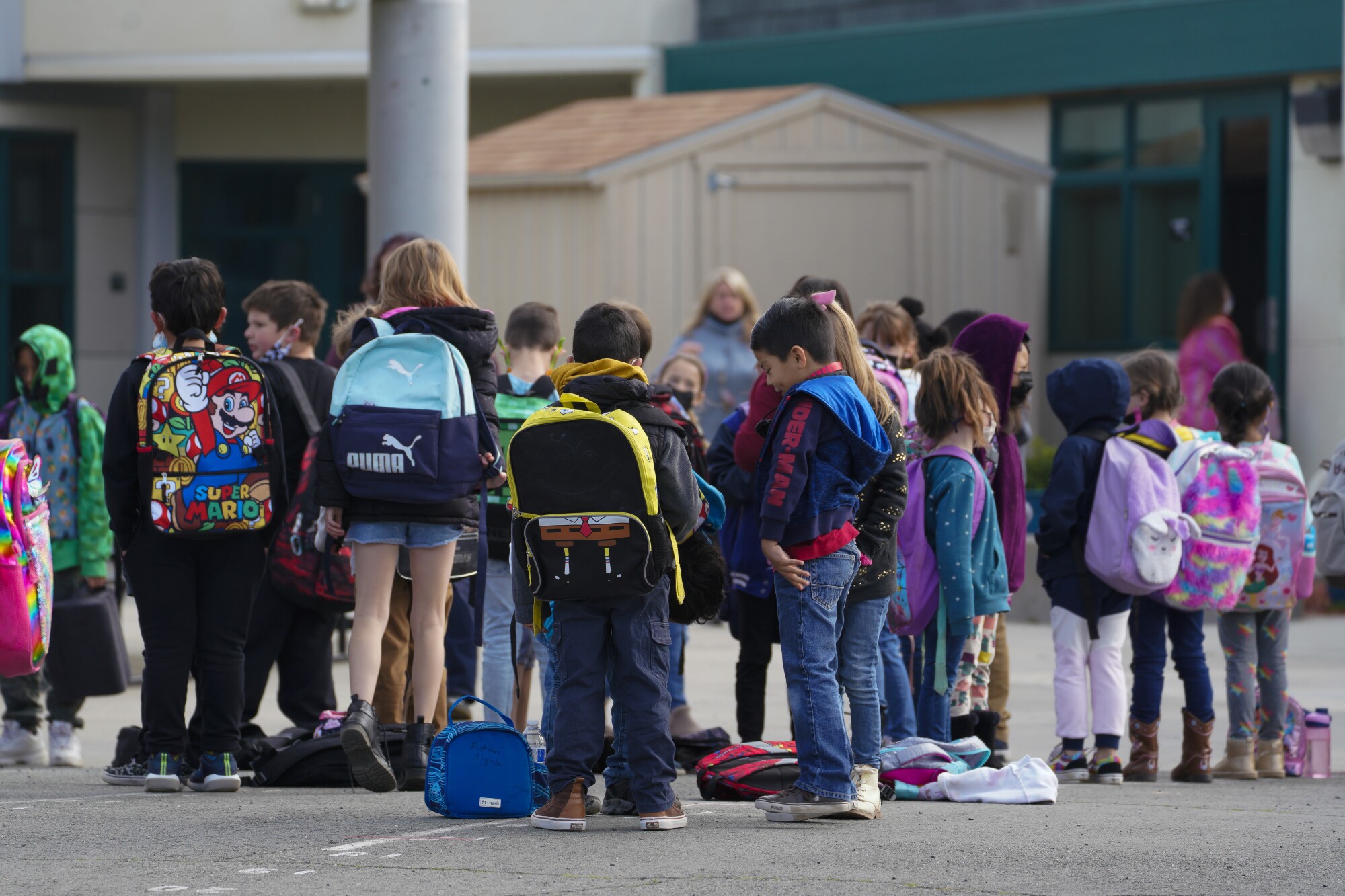 Children line up by assigned classroom for the start of the school day at Campo Elementary School.