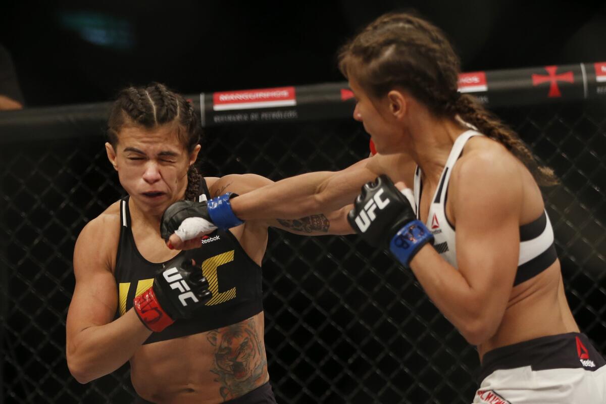 Karolina Kowalkiewicz, right, land a right to the face of Claudia Gadelha during their strawweight fight at UFC 212.