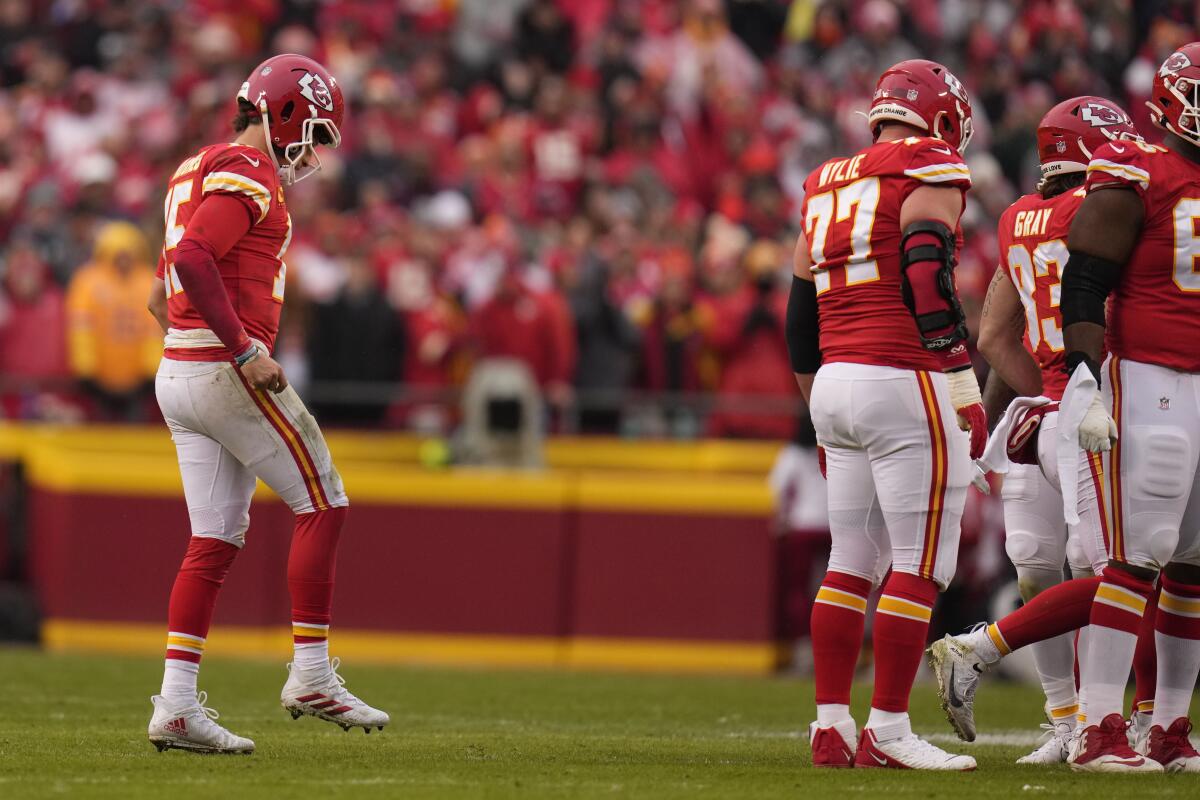 Kansas City quarterback Patrick Mahomes, left, limps back to the huddle against Jacksonville on Jan. 21, 2023.