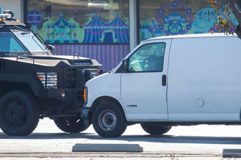 Torrence, CA - January 22: The suspect in a mass shooting in Monterey Park appears slumped over in a van as Emergency services personnel investigate on Sunday, Jan. 22, 2023 in Torrence, CA. (Jay L. Clendenin / Los Angeles Times)