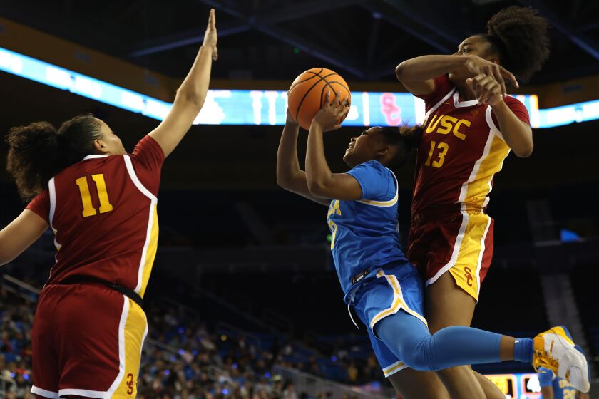 LOS ANGELES, CALIFORNIA - JANUARY 08: Londynn Jones #3 of the UCLA Bruins shoots as Rayah Marshall #13 and Destiny Littleton #11 of the USC Trojans defend during the second half of a game at UCLA Pauley Pavilion on January 08, 2023 in Los Angeles, California. (Photo by Katharine Lotze/Getty Images)