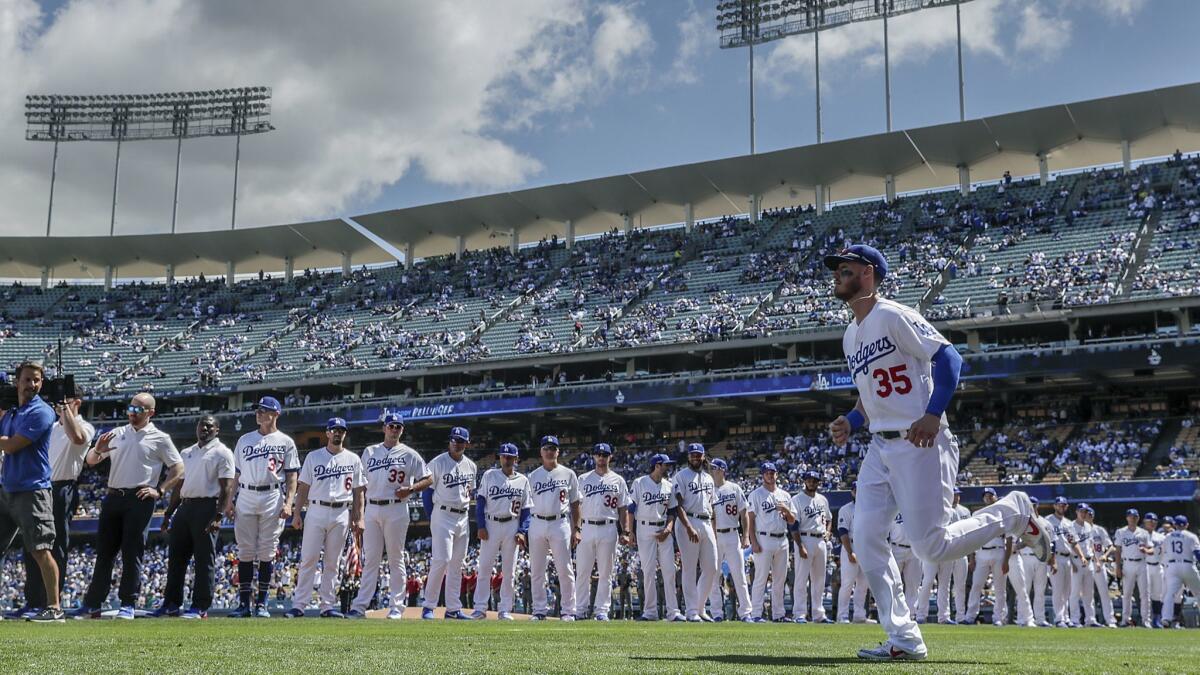 Dodgers' Cody Bellinger is introduced during pregame ceremonies against the Arizona Diamondbacks at Dodger Stadium.