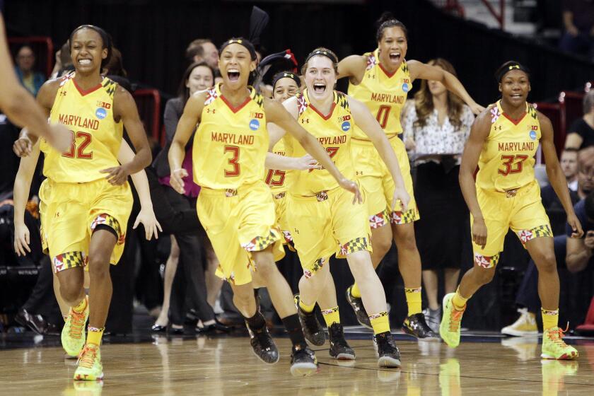 Maryland women's basketball players run to celebrate after defeating Tennessee in the regional final to earn a trip to the Final Four.