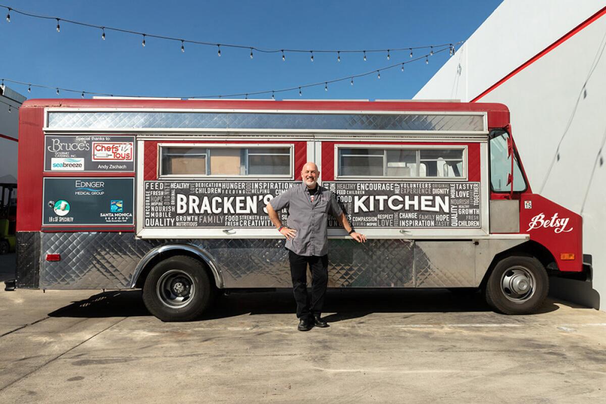 Bill Bracken stands with Betsy, one of the company's food trucks.