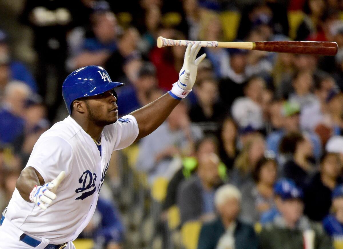 Dodgers right fielder Yasiel Puig flips his bat after connecting for a run-scoring double against the Cardinals in a game June 6, 2015.
