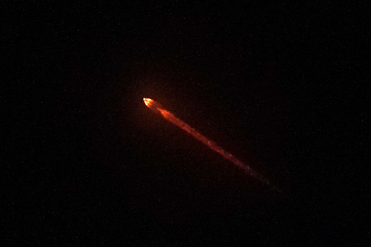 The DART spacecraft is seen in the sky.