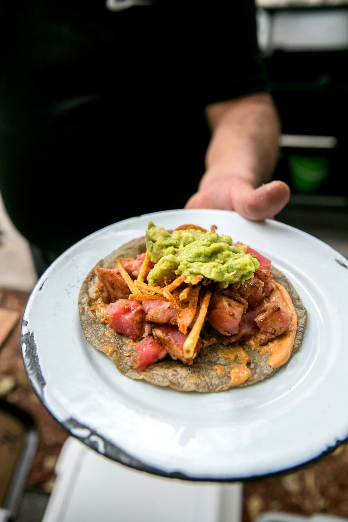 A tuna taco, made and served outdoors on the sidewalk in front of Mexico City restaurant Paramo.
