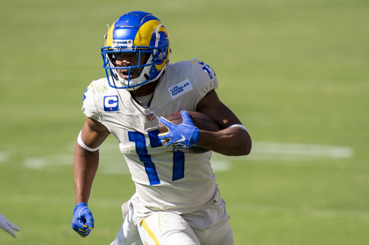 Rams wide receiver Robert Woods runs with the ball in open field.