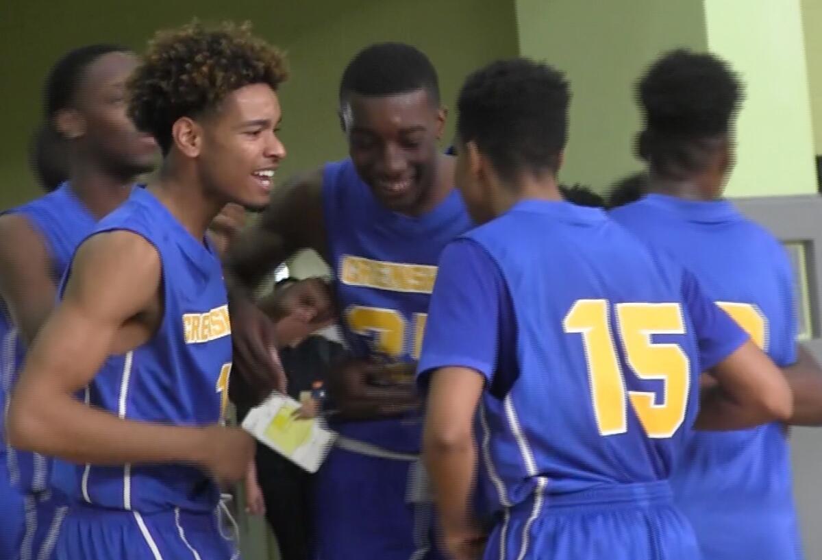 Crenshaw players celebrate 83-78 semifinal win over Fremont in Divison I game.