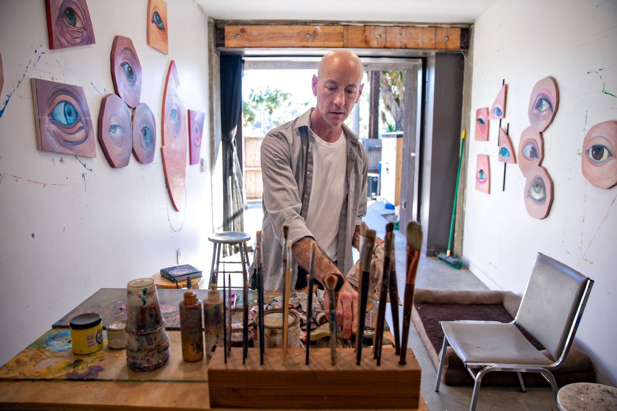 Local artist Daniel Gerwin tidies up his studio.