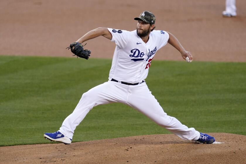 Los Angeles Dodgers starting pitcher Clayton Kershaw throws to the plate during the first inning.