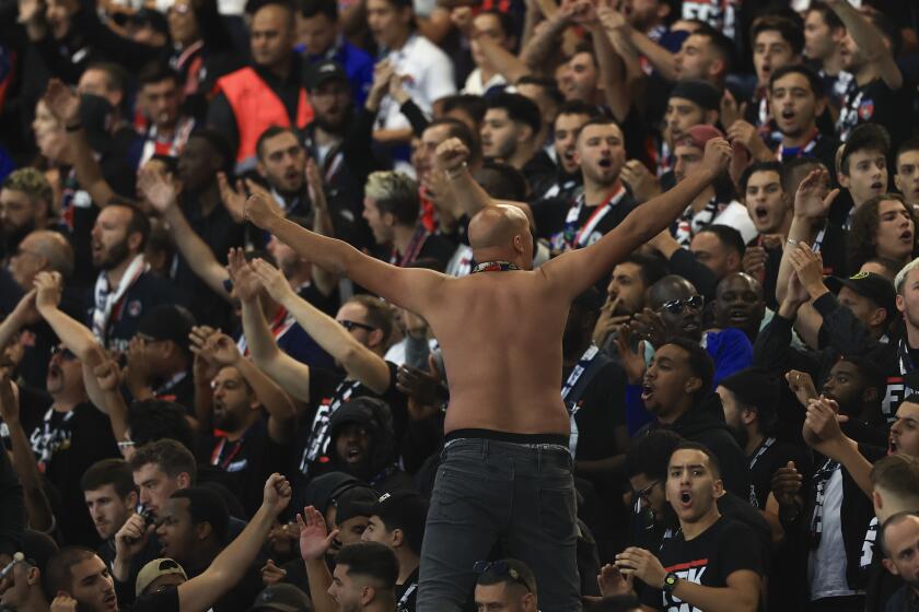 PSG fans cheers ahead of the French League One soccer match between Paris Saint Germain and Olympique de Marseille at Parc des Princes stadium in Paris, France, Sunday, Sept. 24, 2023. (AP Photo/Aurelien Morissard)