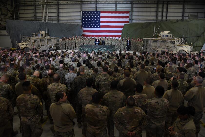 TOPSHOT - US President Donald Trump speaks to the troops during a surprise Thanksgiving day visit at Bagram Air Field, on November 28, 2019 in Afghanistan. (Photo by Olivier Douliery / AFP) (Photo by OLIVIER DOULIERY/AFP via Getty Images)