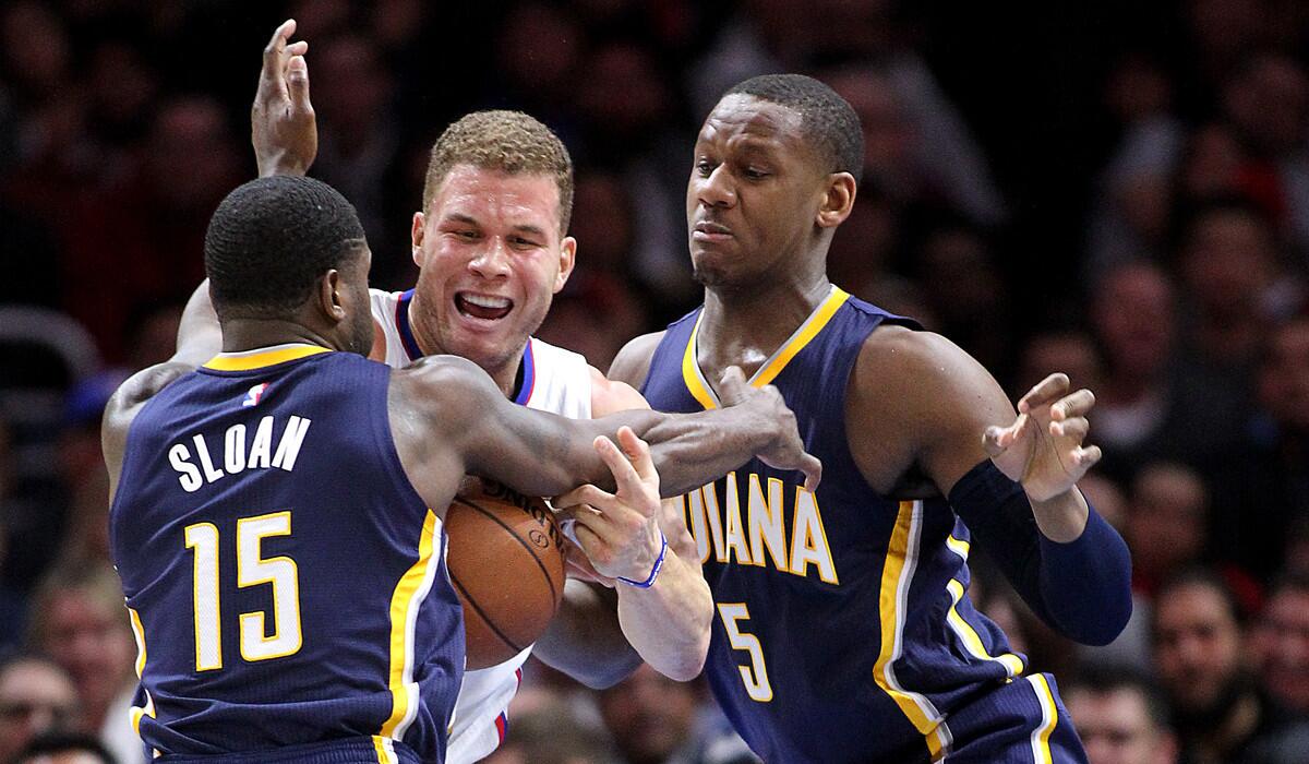 Clippers power forward Blake Griffin is caught between Pacers guard Donald Sloan (15) and forward Lavoy Allen in the first half.