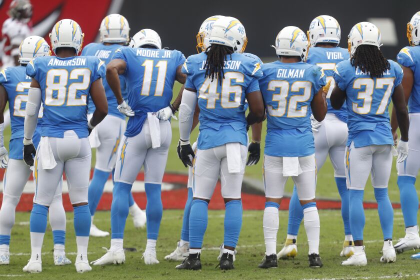 Los Angeles Chargers huddle during a timeout in the second half of an NFL football game, Sunday, Oct. 4, 2020, in Tampa, Fla. (AP Photo/Octavio Jones)