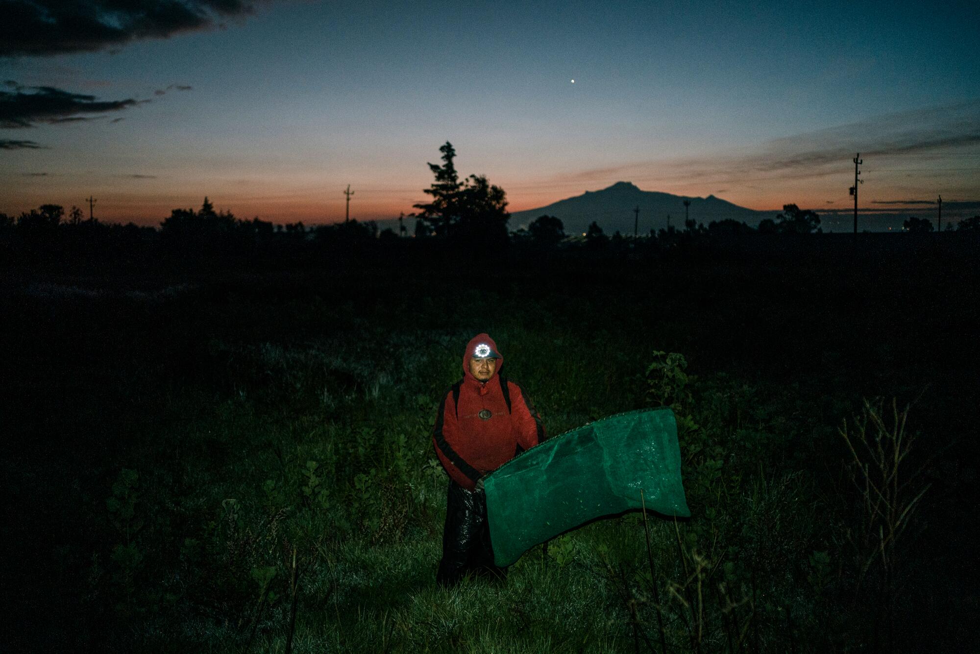 A man in a field before sunrise