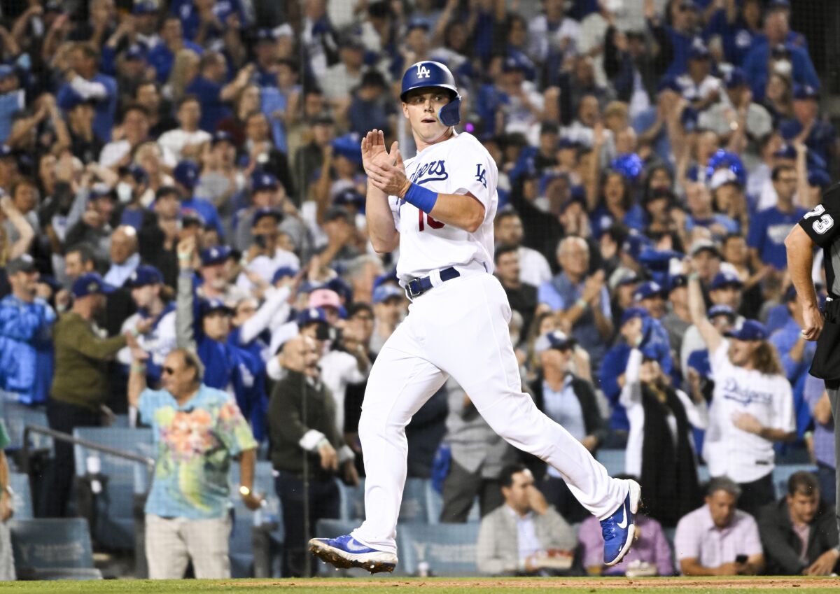 Will Smith celebrates after scoring a run for the Dodgers against the San Diego Padres.