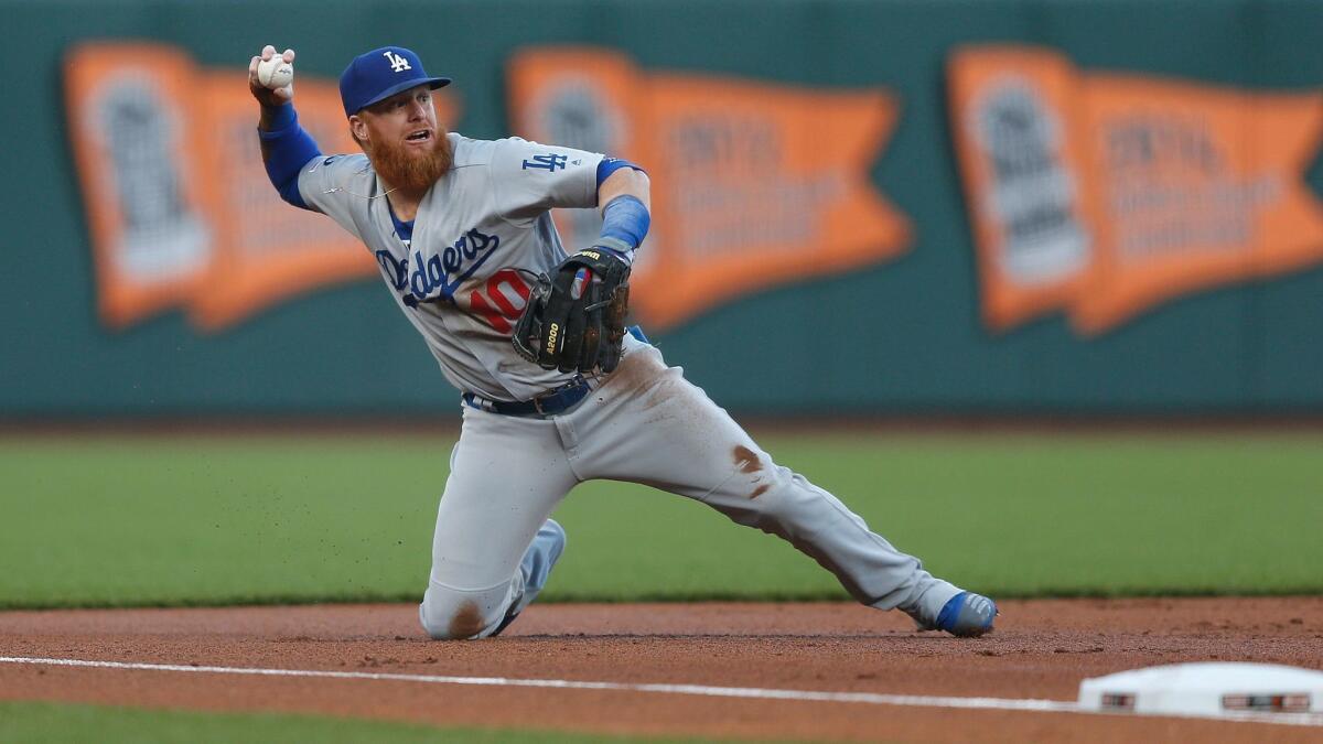 Dodgers' Justin Turner fields the ball at third base in the bottom of the first inning against the San Francisco Giants on Tuesday in San Francisco.