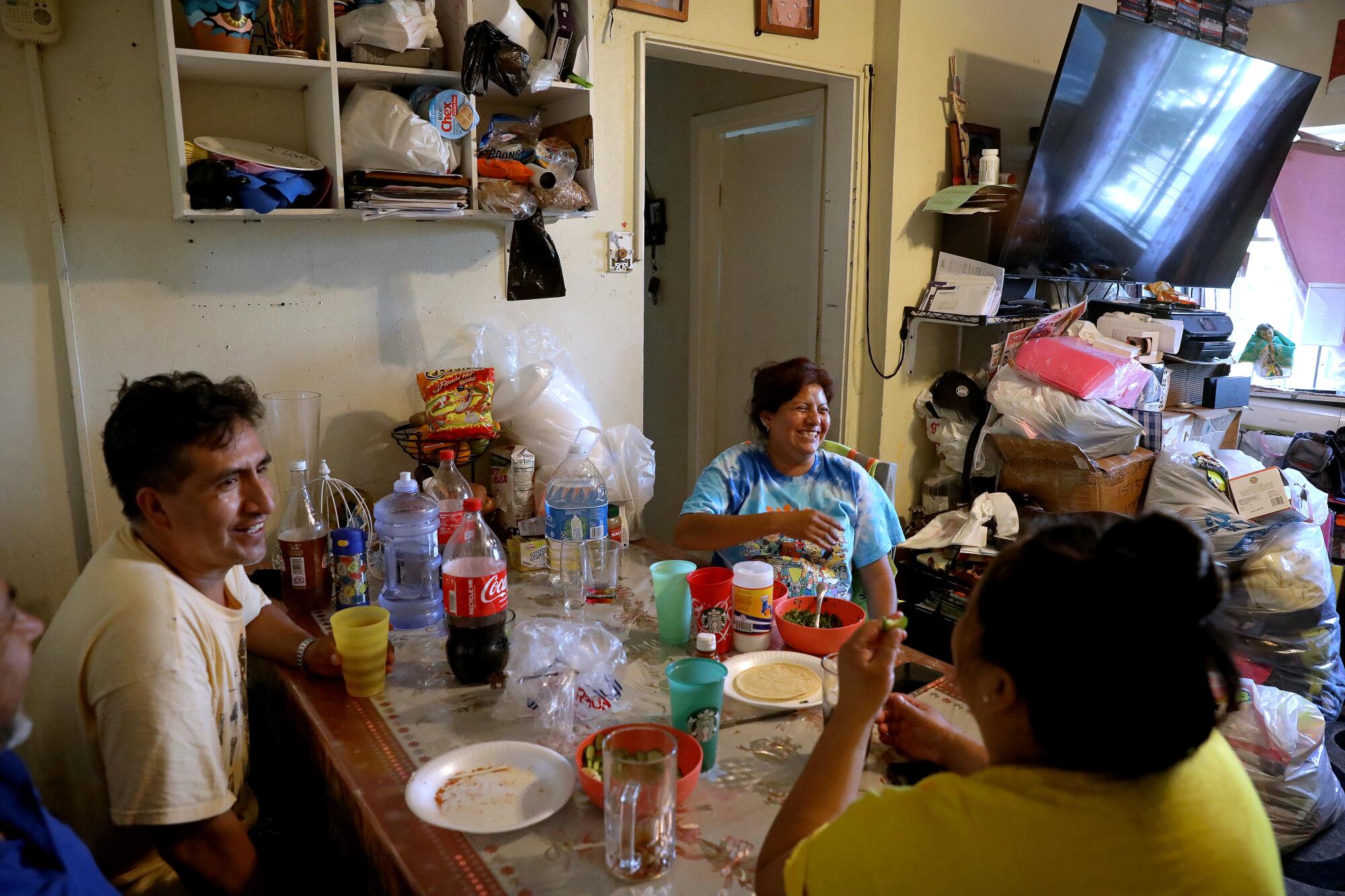 People gathered in a one-bedroom apartment in the Pico-Union neighborhood of Los Angeles. 