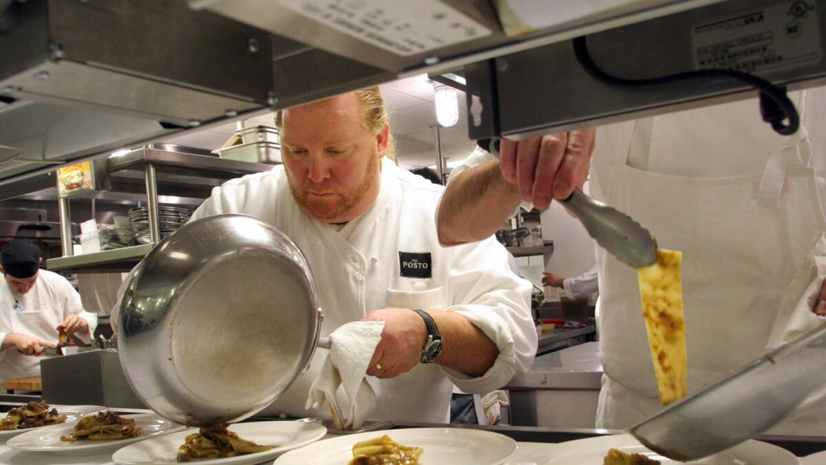 Chef Mario Batali, shown in 2006, said he will step away from the day-to-day operations of his businesses after allegations of sexual misconduct.