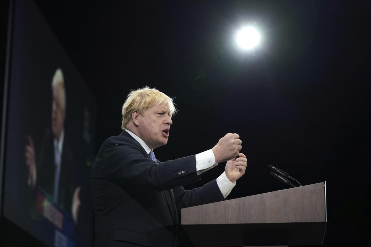 Britain's Prime Minister Boris Johnson makes his keynote speech at the Conservative party conference in Manchester, England, Wednesday, Oct. 6, 2021. (AP Photo/Jon Super)