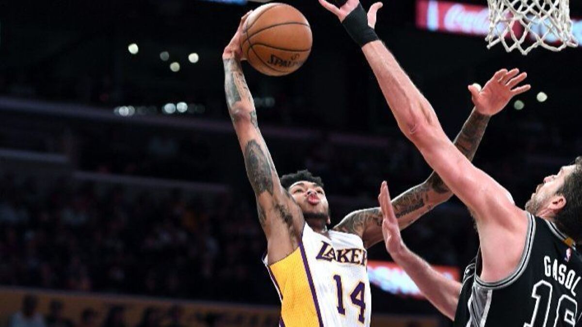 Lakers forward Brandon Ingram goes up for a dunk on Spurs forward Pau Gasol at Staples Center on Sunday.