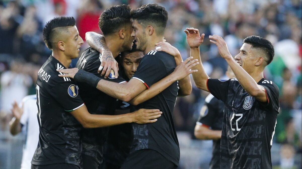 Mexico soccer team celebrates their goal during a CONCACAF Gold Cup match between Mexico and Cuba at the Rose Bowl on Saturday. Mexico won 7-0.