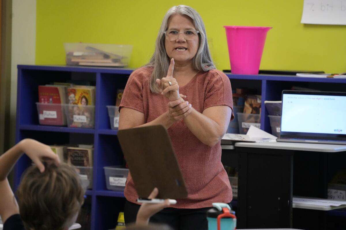 A math teacher leads a classroom.