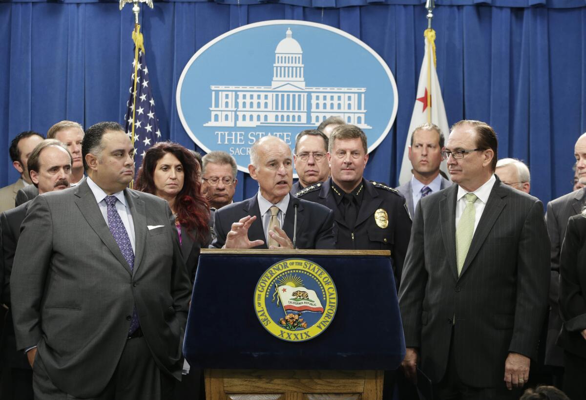 State Senate Minority Leader Robert Huff (R-Diamond Bar), right, stands next to Gov. Jerry Brown, center, at a Capitol news conference. Huff has filed papers to raise money for a campaign for a seat on the Los Angeles County Board of Supervisors.