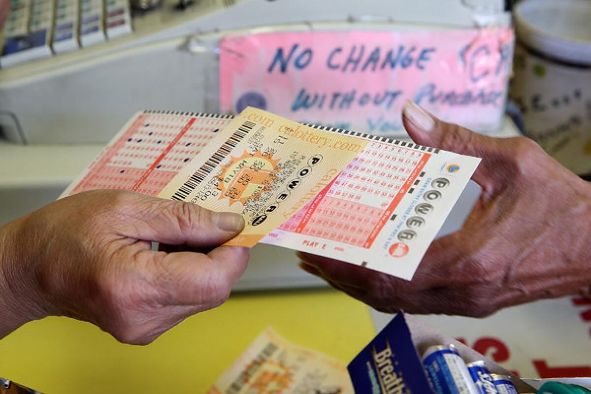 A customer purchases a Powerball ticket Friday in San Francisco, joining people across the state lining up for a chance at the monster jackpot.
