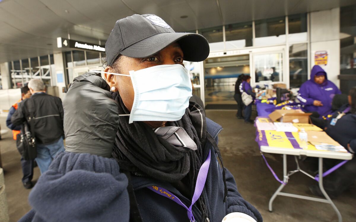 LAX worker dons a face mask