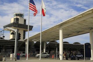 Travelers prepare to enter Oakland International airport Tuesday, Nov. 26, 2013, in Oakland, Calif. (AP Photo/Ben Margot)
