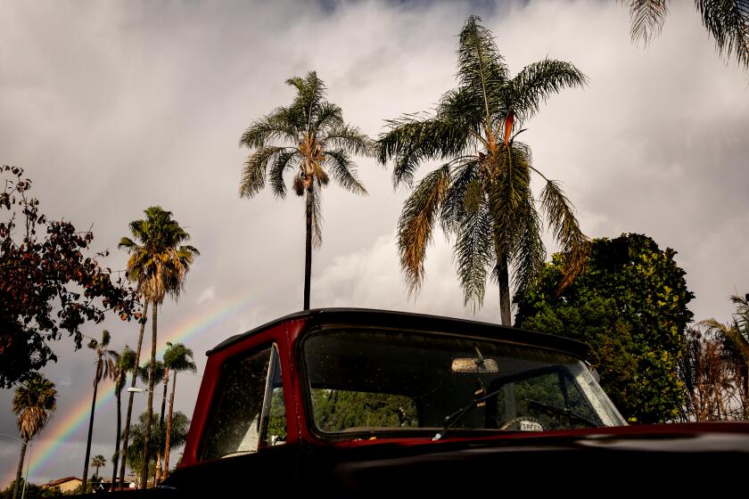 SAN DIEGO, CA - DECEMBER 28: A rainbow forms over a truck parked in the street in the Kensington neighborhood on Monday, Dec. 28, 2020 in San Diego, CA. (Sam Hodgson / The San Diego Union-Tribune)`